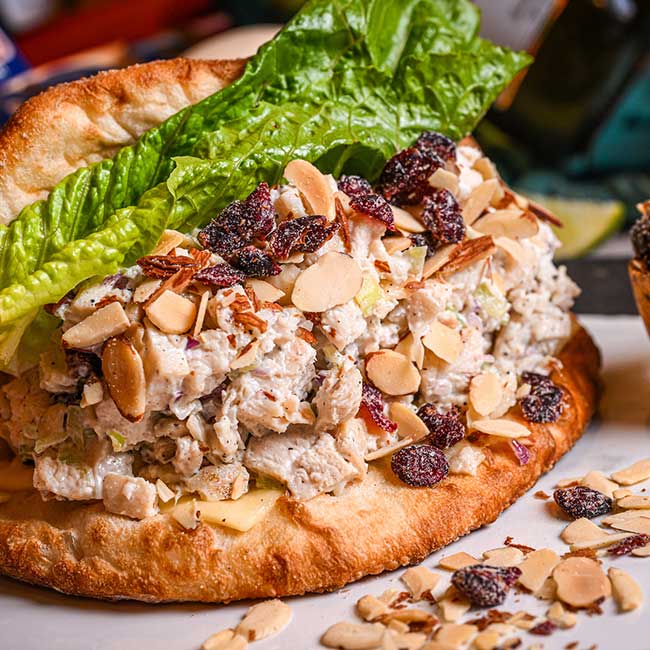 Chicken salad sandwich with lettuce, sliced almonds, and cranberries—a Tucson sandwiches favorite.